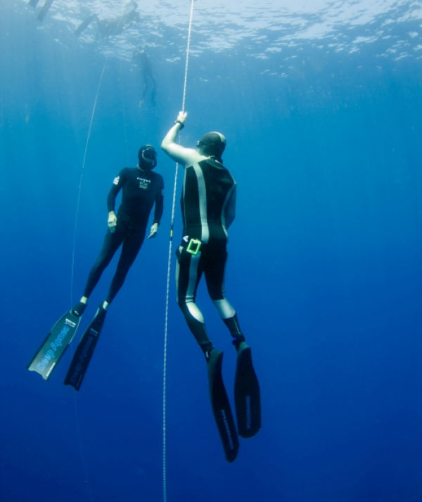 instructor teaches underwater